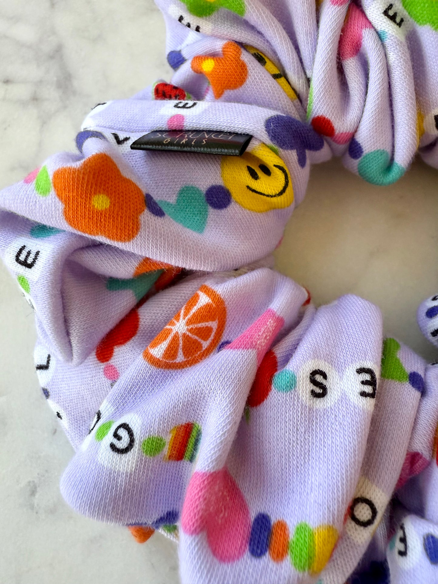 Taylor. | a friendship bracelet print Scrunchie
