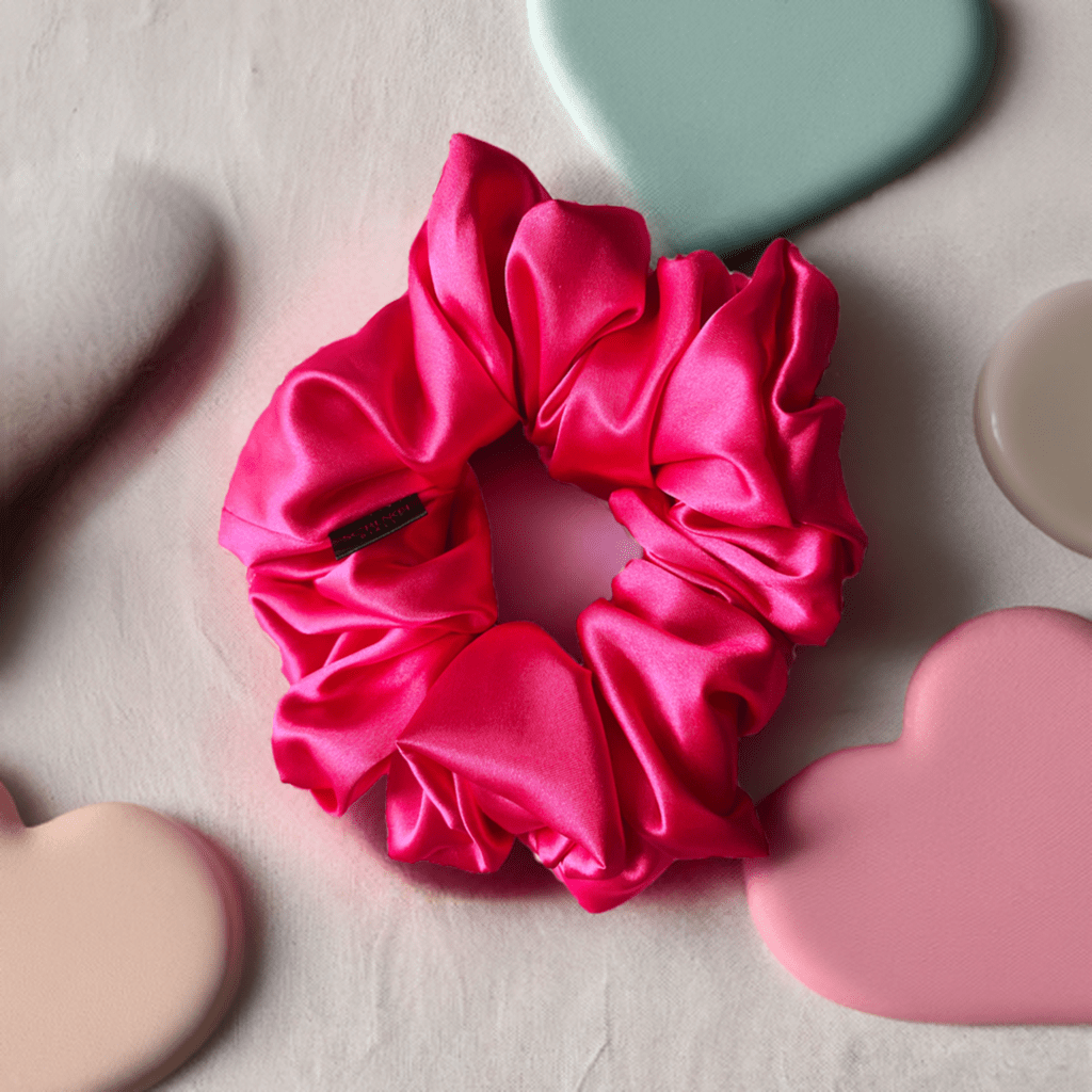 Aluna. | a pink satin scrunchie.
