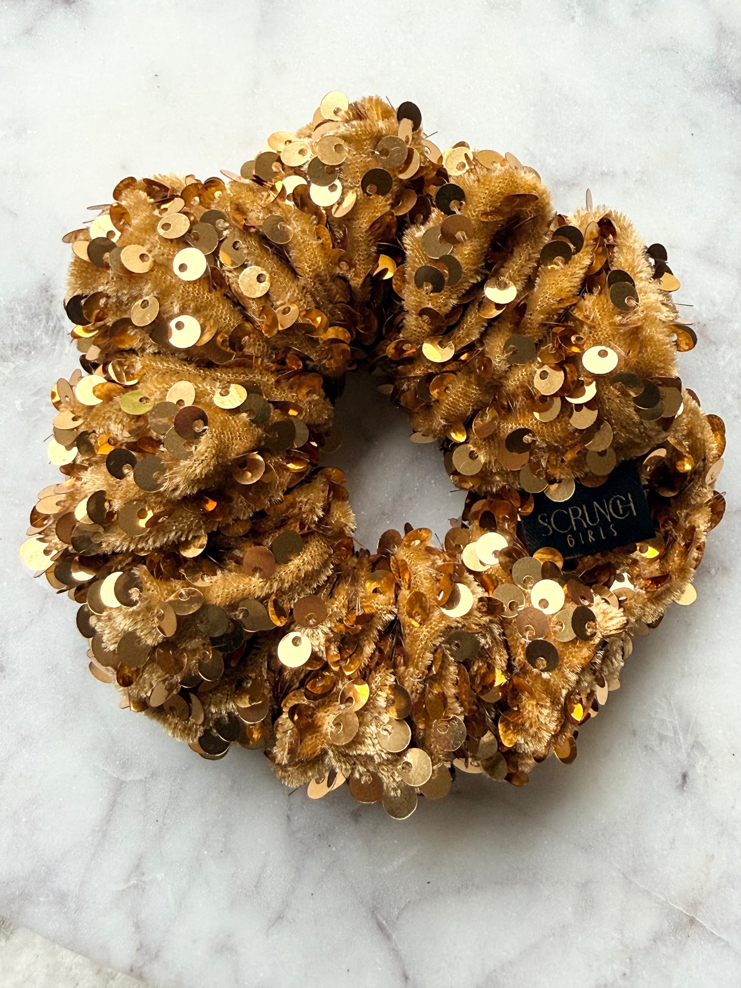 Jenaye. | A gold sequin Scrunchie.