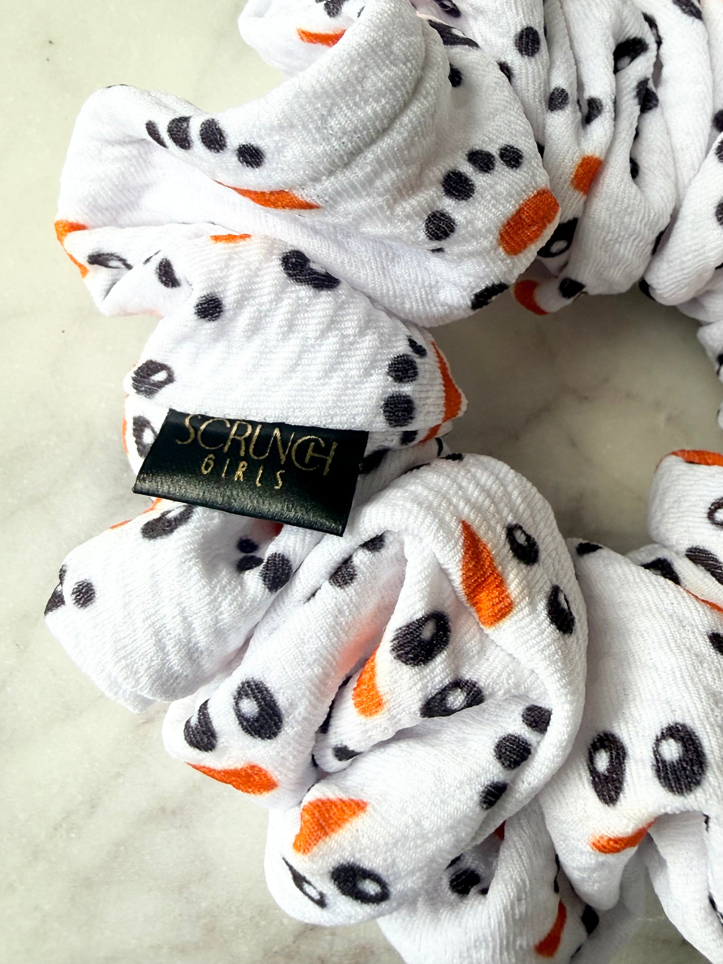 Snowman Face| a white bullet fabric Scrunchie with a snowman print.