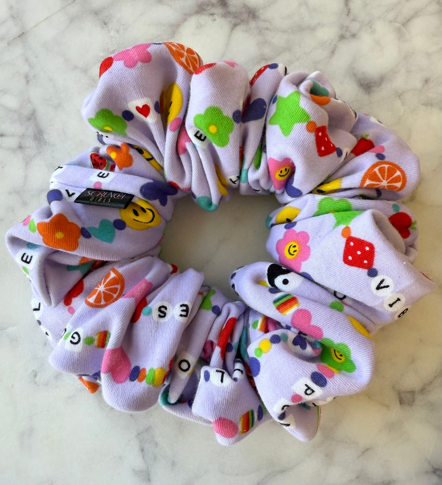 Taylor. | a friendship bracelet print Scrunchie