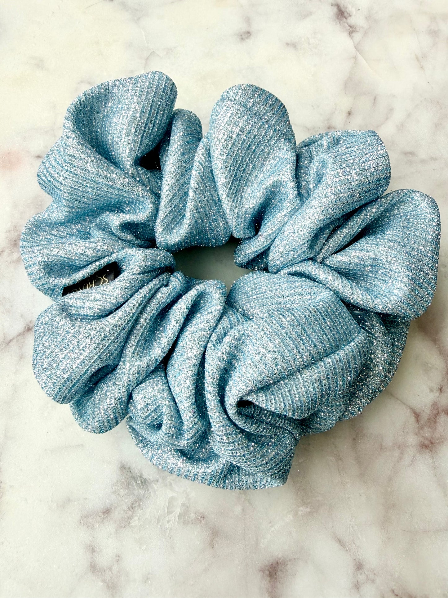 Blue scrunchie on a marble surface